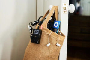 Hessian bag stuffed full of old electricals leaning against a door.